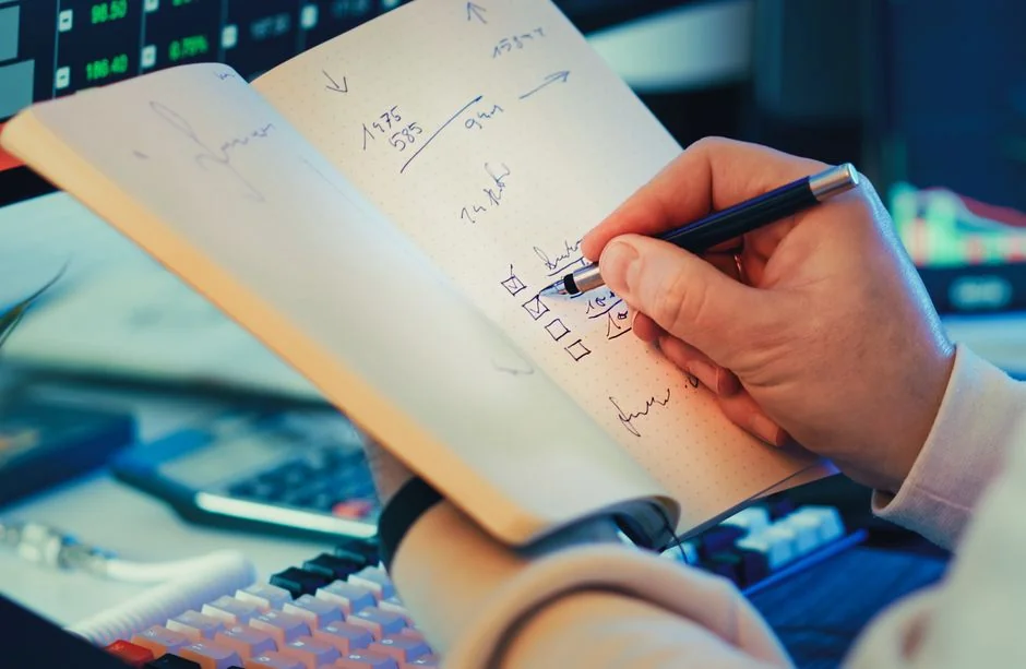 Close-up of a social media marketing document on a desk with a pen and notebook.